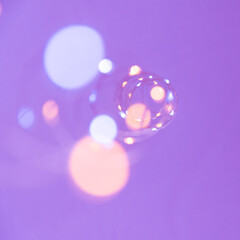 Texture of New Year or Christmas garland on a purple background. Abstract painting