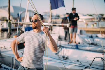 Preparation for the regatta at the yachting school at the marina with sailing yachts.