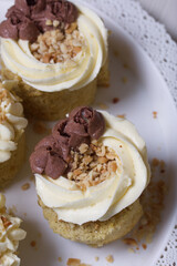 Sponge cake with butter cream. Sprinkled with peanuts. Close-up shot.