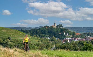 happy senior woman riding her electric mountain bike on sunny  day in the Bottwartal Valley with...