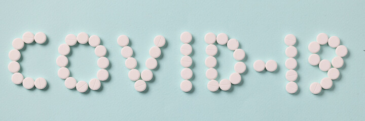 Inscription covid 19 is made of white pills