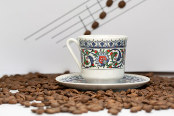 a cup of turkish coffee among the coffee grains