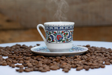 a cup of turkish coffee among the coffee grains