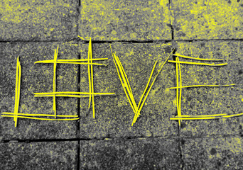 Word "Love" in yellow sticks on street