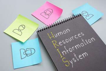 Human resources information system HRIS is shown on the photo using the text