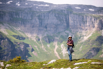 Fototapeta na wymiar hiker on the top of a mountain range in the Swiss Alps