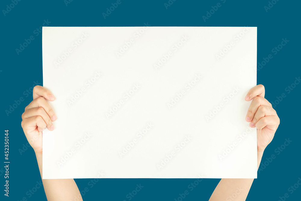 Wall mural women hand holding white blank paper isolated on blue background with clipping path