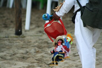 selling Mexican toys for tourists on the Caribbean beaches