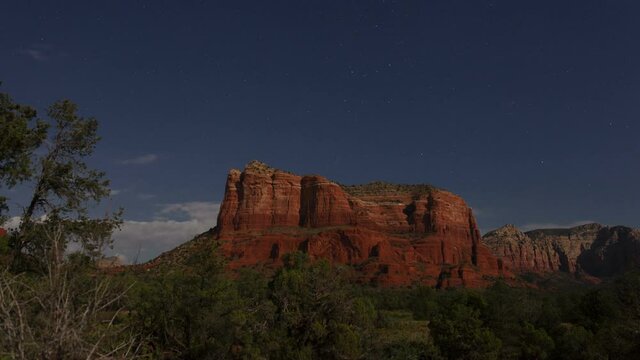 Time lapse of stars and clouds above Sedona red rocks in the moonlight