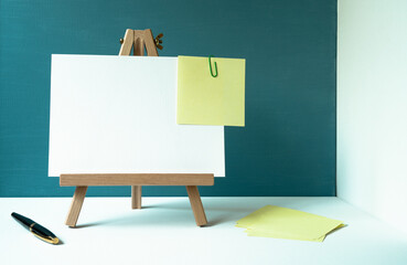 wooden easel with a white board with space for text, pen, yellow cards, reminders