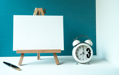 wooden easel with a white board with space for text, pen, white clock