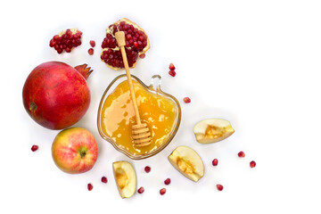 Honey in glass bowl, red apples, garnets, wooden honey dipper on a white background with space for text. Top view, flat lay