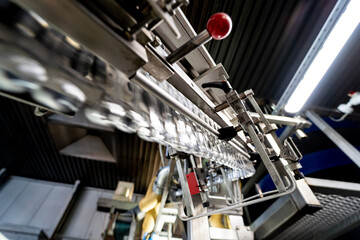 Automatic filling machine pours water into plastic PET bottles at modern beverage plant.