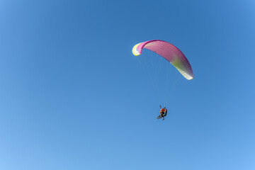 Paragliding flight in the air over the mountains.