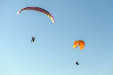 Paragliding flight in the air over the mountains.