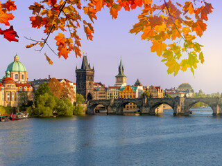 Prague cityscape with Charles bridge over Vltava river in autumn sunset, Czech Republic