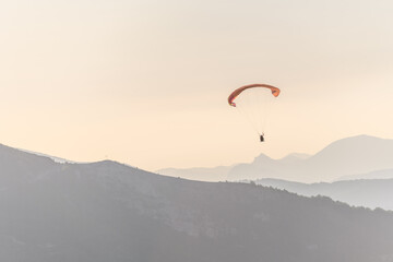 Paragliding flight in the air over the mountains.