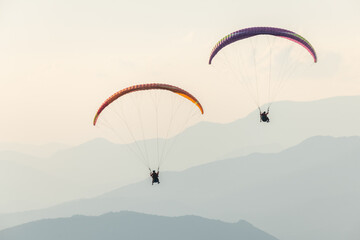 Paragliding flight in the air over the mountains.