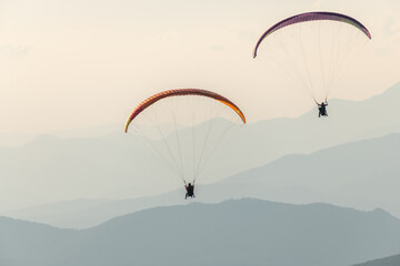 Paragliding flight in the air over the mountains.