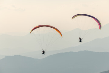 Paragliding flight in the air over the mountains.