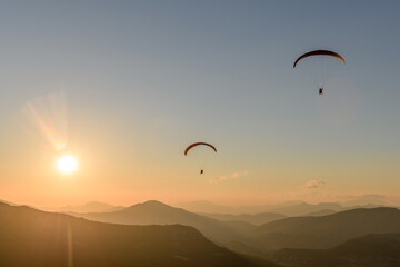 Paragliding flight in the air over the mountains.