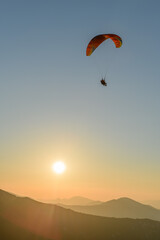 Paragliding flight in the air over the mountains.
