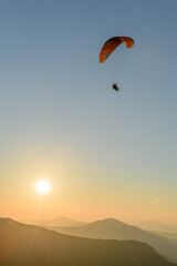 Paragliding flight in the air over the mountains.
