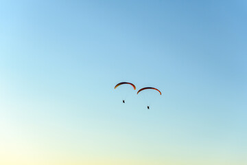 Paragliding flight in the air over the mountains.