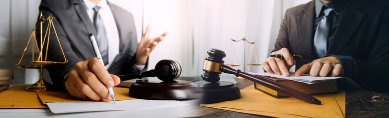 Business and lawyers discussing contract papers with brass scale on desk in office. Law, legal...