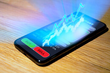 Aktienhandel auf dem Smartphone, mehr Charts und Analysen als Hologramm über dem Display,...