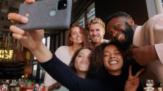 Slow motion of friends in wine bar taking selfie