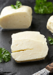 Sliced halloumi cheese with mint on stone board