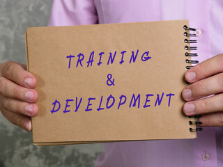 Business concept about TRAINING & DEVELOPMENT with inscription on the page.