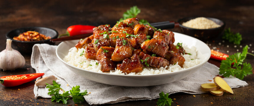 Chinese traditional cuisine sticky braised pork belly with rice on white plate