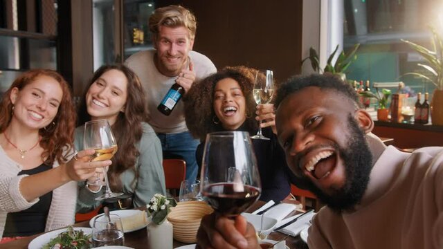 Slow motion of friends in wine bar posing for selfie