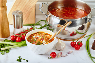 Ukrainian and Russian traditional red beet soup borsch, made from beets, cabbage, potatoes, beef and tomatoes