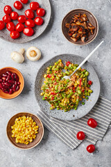 Quinoa salad with green beans, corn, red bell peppers, peas and soybeans. Useful vegetable mix