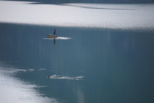 Fisherman on boat in Corlo lake in Arsi&egrave;