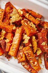 Sweet potato with cheese backed in bowl on grey background