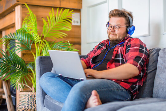 Man Works At Home Using A Laptop. He Is Hosting A Business Meeting - An Online Video Call.