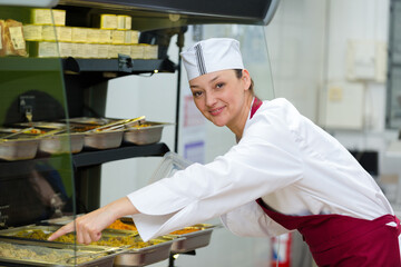 female canteen worker preparing the tray