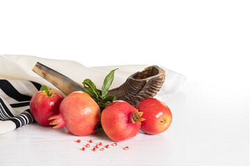 Rosh Hashanah (jewish holiday) concept. Tallit, shofar (horn),  apple and pomegranate isolated on...