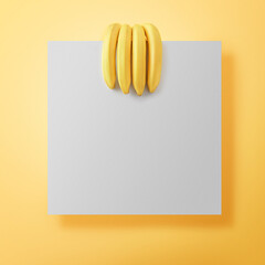 Ripe bananas on yellow background with copy space. Bunch of bananas in the form of a human hand holding a square note.