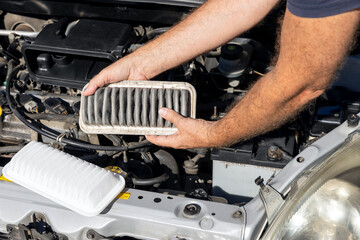 Replacing the dirty engine air filter for a car