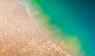 Clean sandy beach and turquoise water drone view