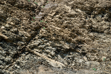 Complete setting of the textures of the face of a smooth rock with stratum outdoors.