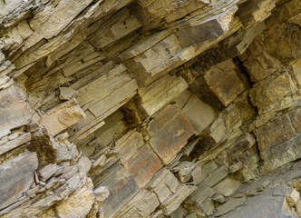 Complete setting of the textures of the face of a smooth rock with stratum outdoors.