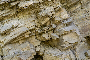 Complete setting of the textures of the face of a smooth rock with stratum outdoors.