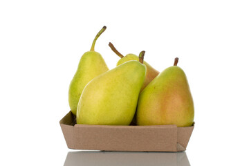 Four bright yellow juicy pears in a paper bowl, close-up, isolated on white.