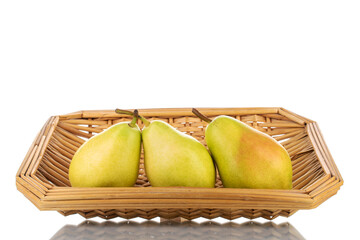 Three bright yellow juicy pears with a basket, close-up, isolated on white.